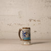 Ceramic mug with decorative design on a textured surface