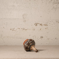 Ceramic vase with decorative patterns on a textured surface and background