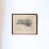 Framed black and white landscape drawing on a white wall