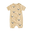Beige baby romper with dog face patterns on a white background