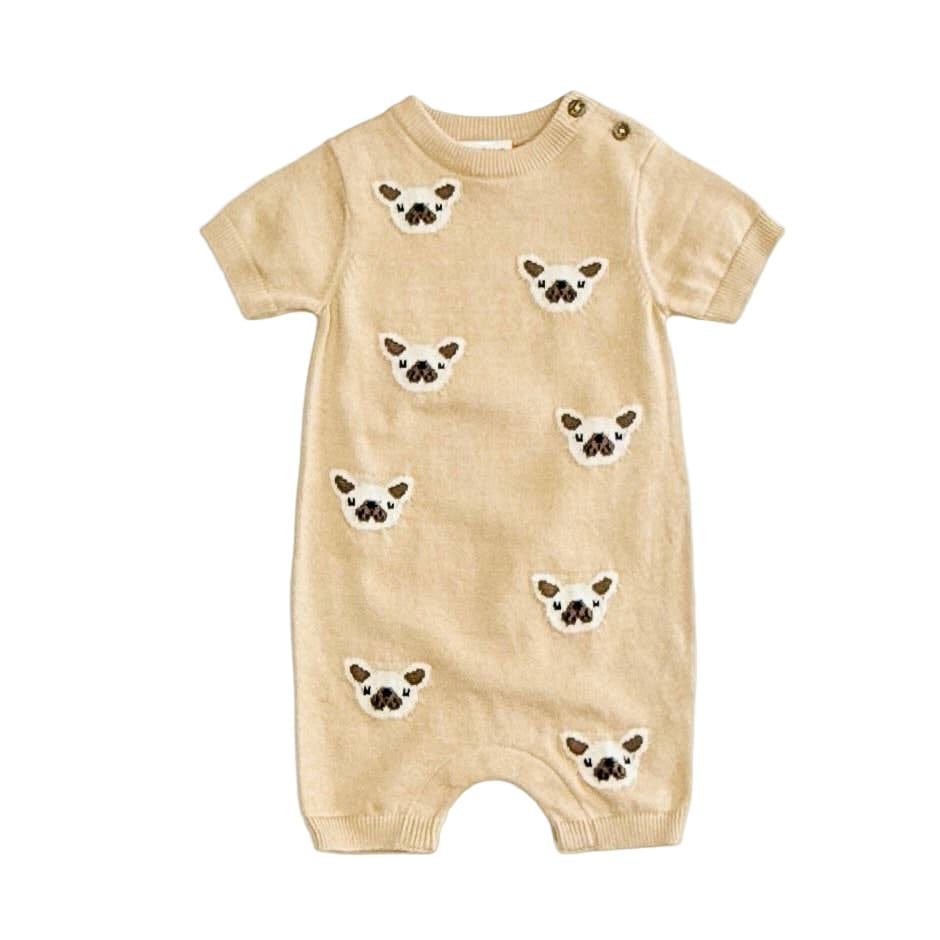 Beige baby romper with dog face patterns on a white background