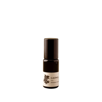 Small black bottle with a white label on a white background