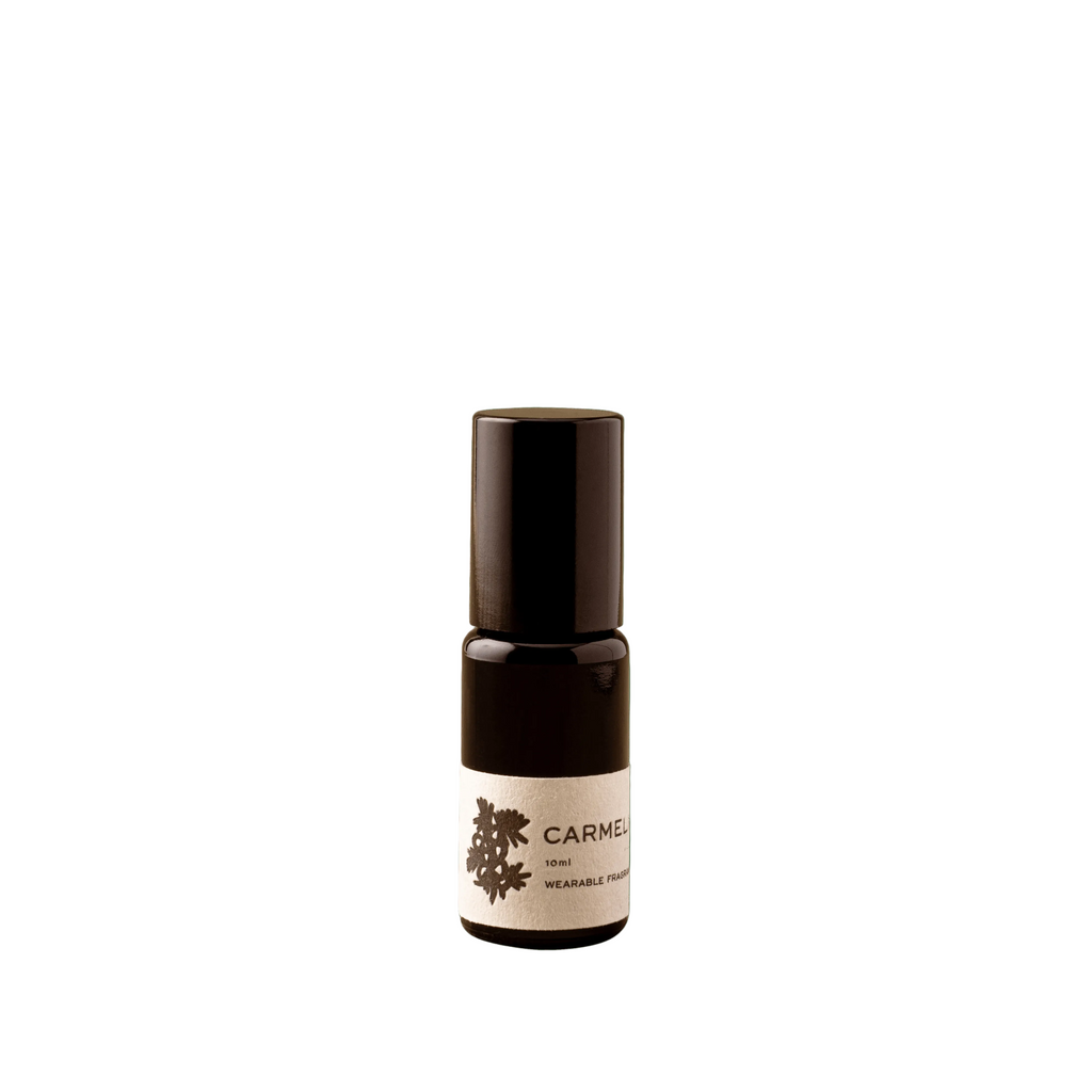 Small black bottle with a white label on a white background