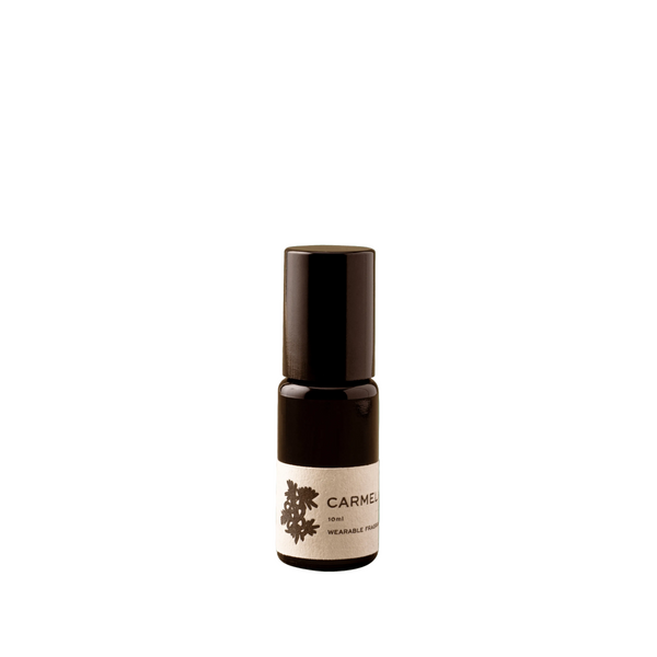 Small black bottle with a white label on a white background