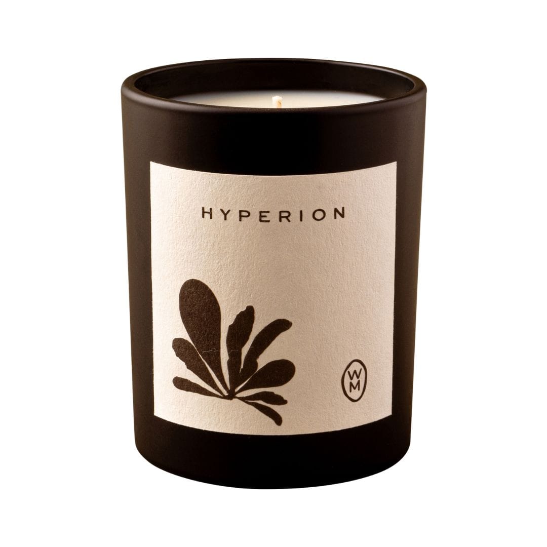Candle with 'Hyperion' label and leaf design on a white background