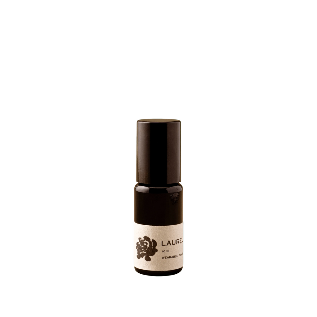 Small brown bottle with a white label on a green background