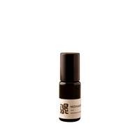 Small brown bottle with a label on a green background