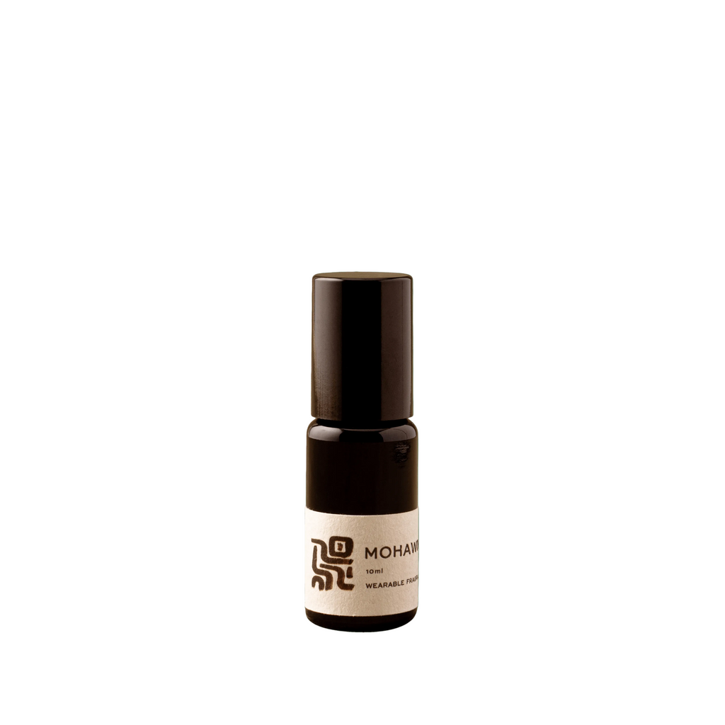 Small brown bottle with a label on a green background