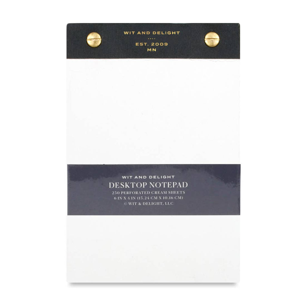 A Wit and Delight Desktop Notepad with cream-colored sheets, a dark charcoal gray top header, a matching dark gray middle band, and two gold metal grommets at the top.