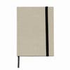 A hardcover notebook with a textured beige linen cover, featuring a black elastic closure band and a matching black ribbon bookmark, shown on a plain white background.