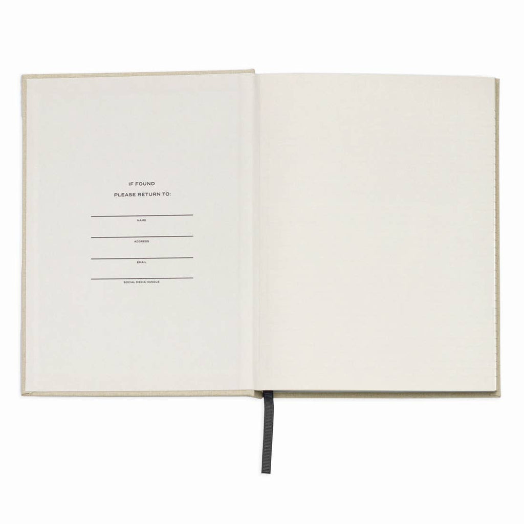 Open notebook with a blank page and text on a white background