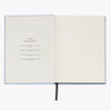 Open notebook with a form on the first page on a white background