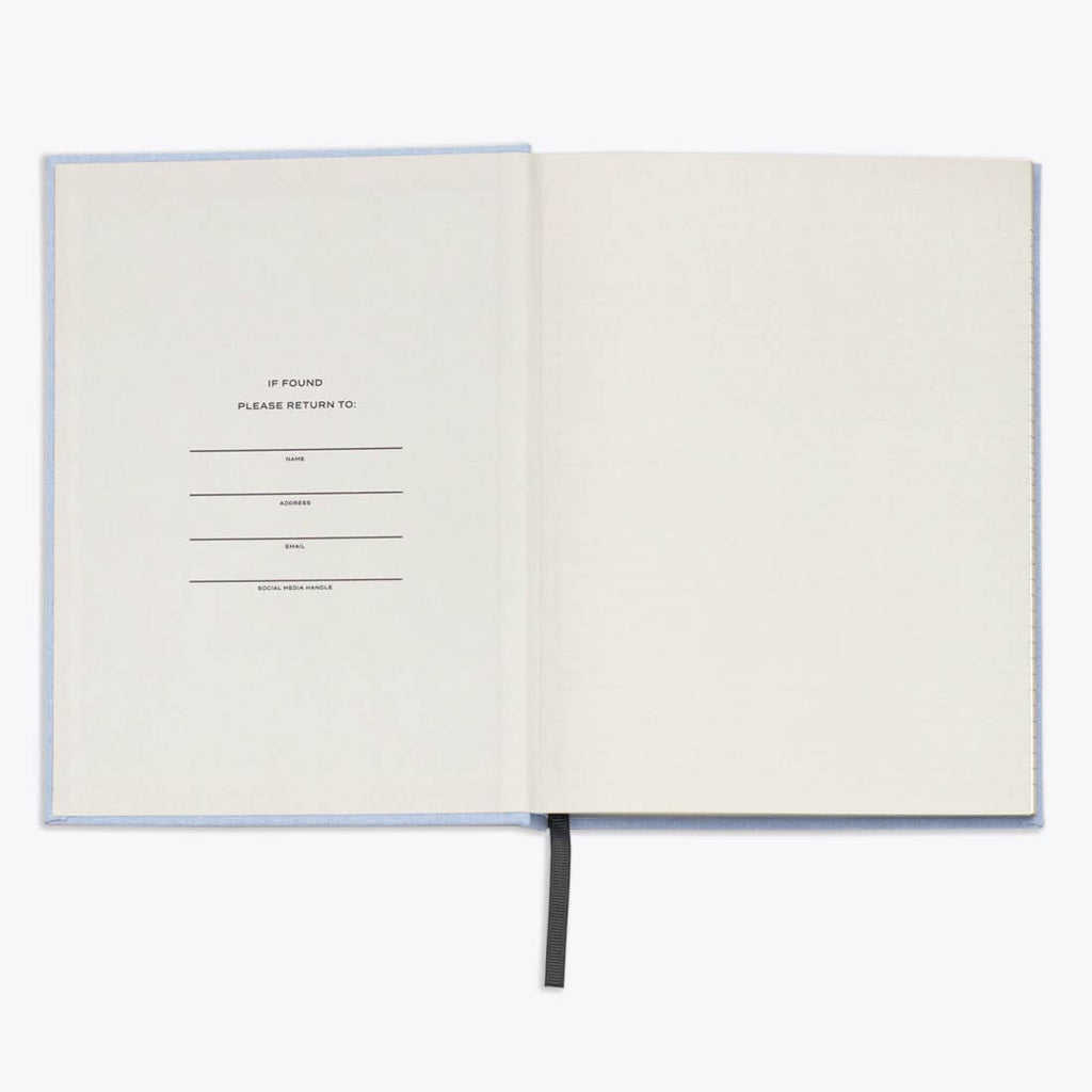 Open notebook with a form on the first page on a white background