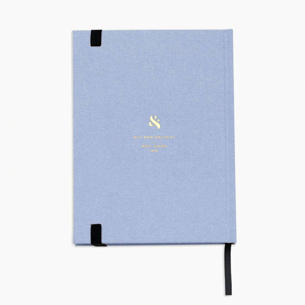Light blue notebook with a black strap on a white background
