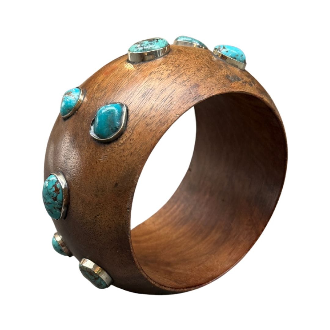 Wooden bracelet with turquoise stones on a white background