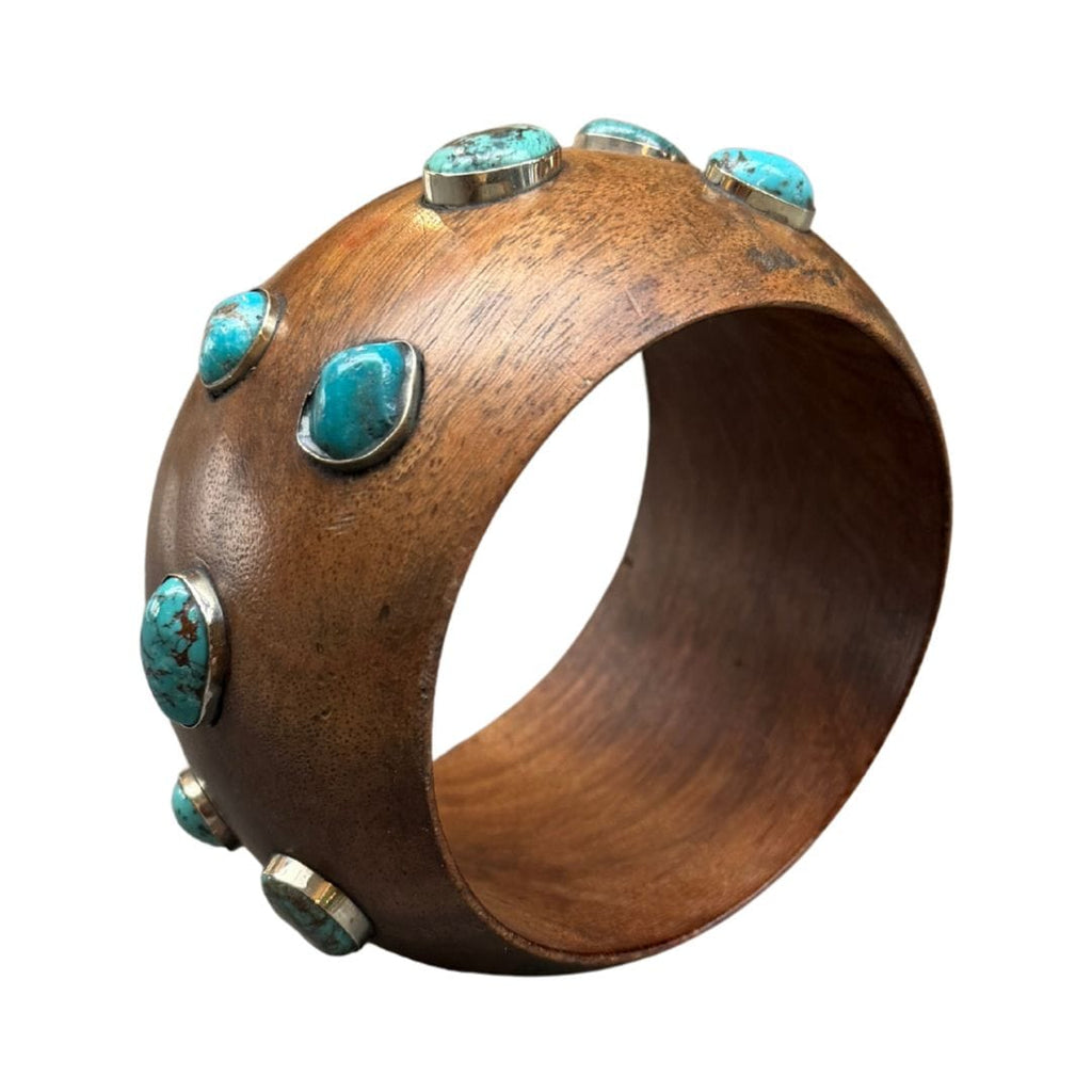 Wooden bracelet with turquoise stones on a white background