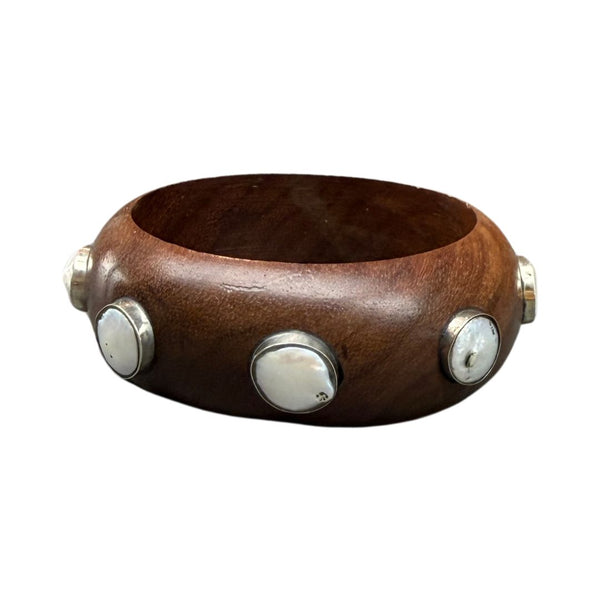 Wooden bracelet with silver and pearl accents on a white background