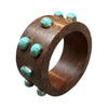 Wooden bracelet with turquoise stones on a white background