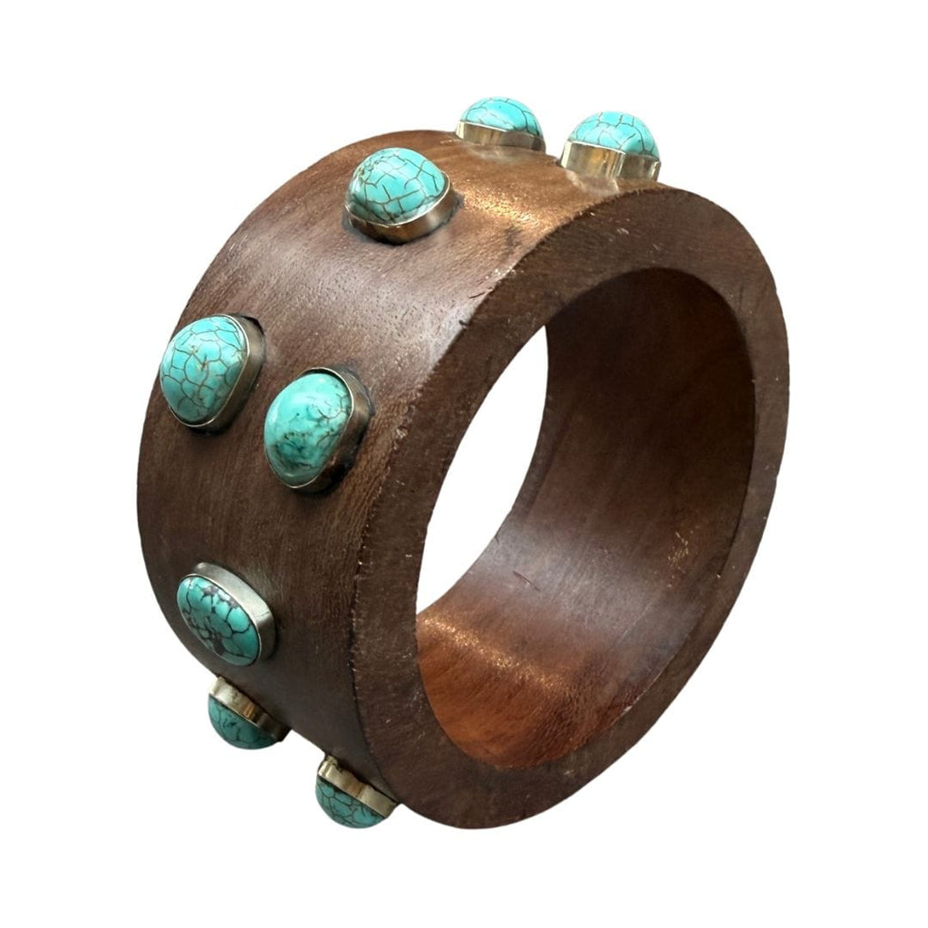 Wooden bracelet with turquoise stones on a white background