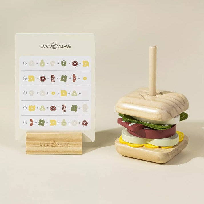 Wooden toy hamburger with a stand and COCO VILLAGE branding on a beige background