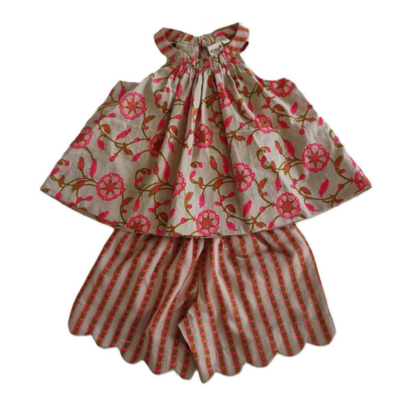 A two-piece children's outfit featuring a sleeveless top with a pink floral print on a beige background and matching striped shorts with scalloped edges.